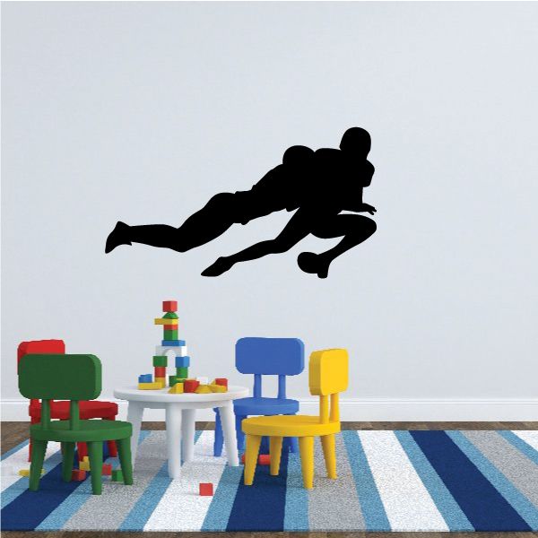 Football player wall decal, black vinyl silhouette with running pose.