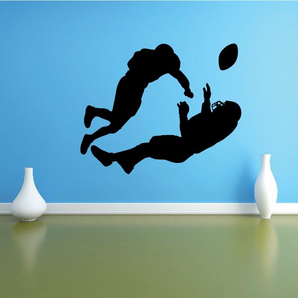Football player wall decal, black vinyl silhouette in mid-kick pose