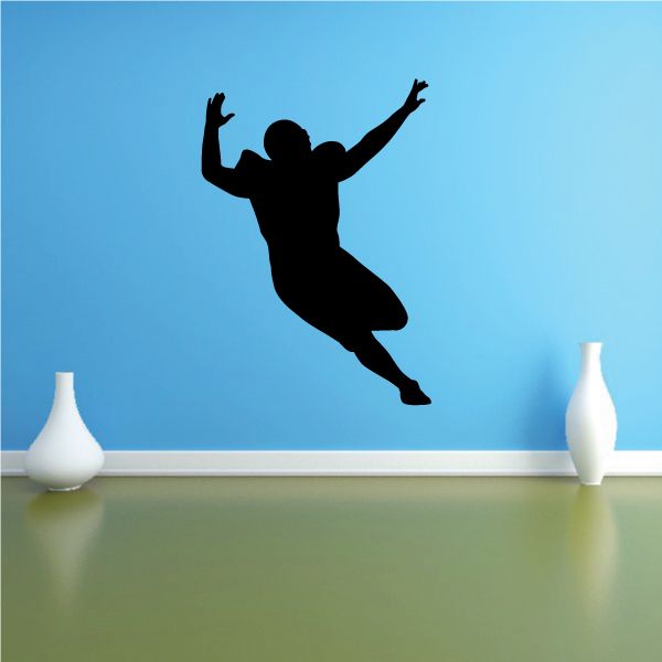 Football wall decal: black silhouette of a jumping football player with arms up