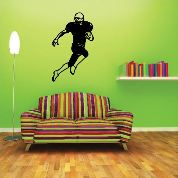 Football wall decal featuring a black running football player silhouette