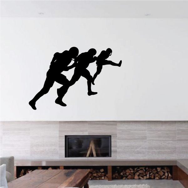Football wall decal with black silhouettes of three football players in action