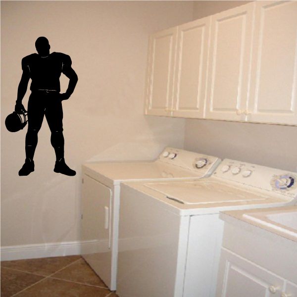 Black football player vinyl wall decal with raised ball pose