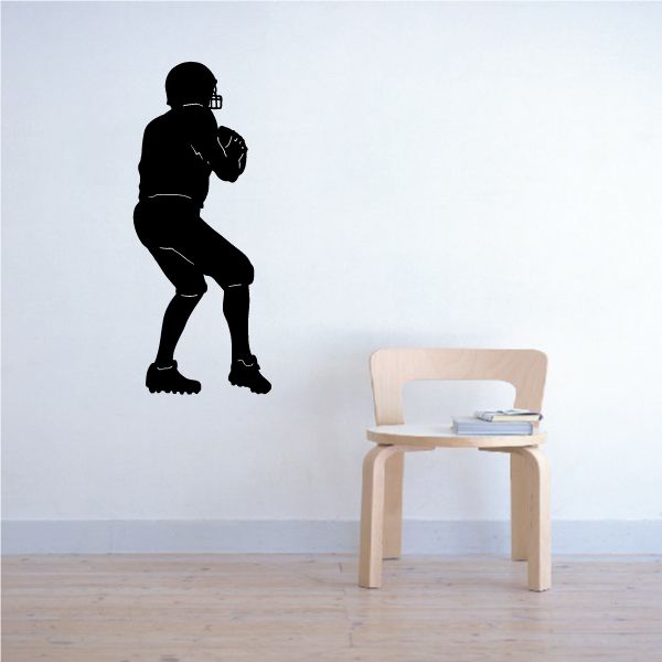 Football player wall decal, dark vinyl silhouette of a running athlete