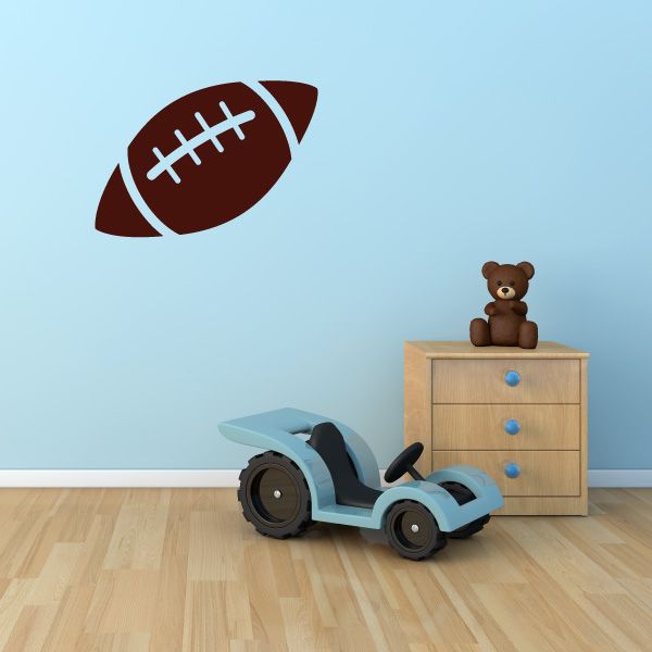 Football wall decal in brown with white stitched laces and outline