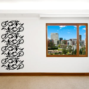 Ornate black floral wall decal with scrolling vine flourish