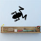 Black frog silhouette wall decal, hopping pose with open mouth and long legs.