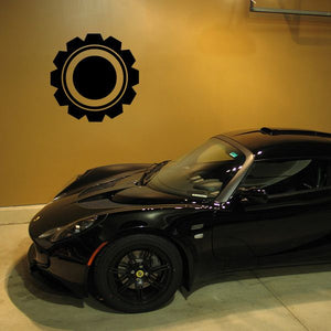 Black and gold gear-shaped decal with a center circle