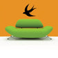 Black swallow bird wall decal with wings spread, flying upward.