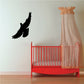 Dove decal sticker with black flying bird silhouette on a light wall