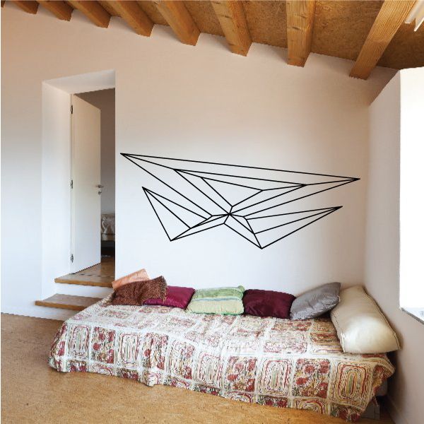 Symmetric geometric pinstripe vinyl decal with black line-art wings on wall