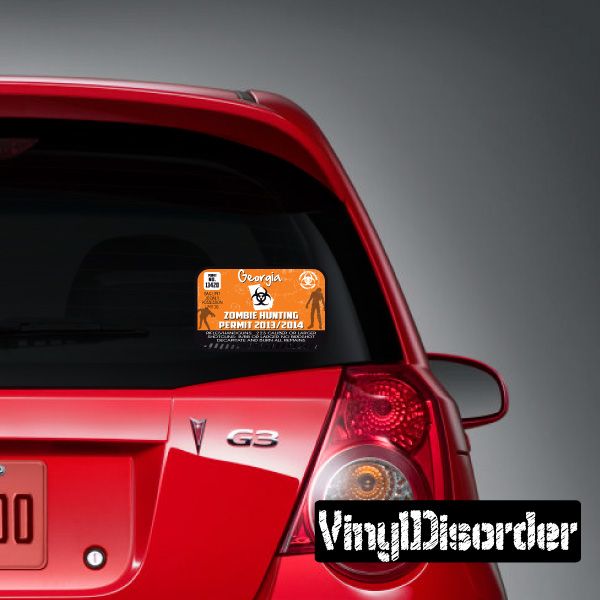 Zombie hunting permit sticker, orange graphic with text on a car window