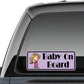 Baby on Board sticker with cartoon girl and purple border, on car window