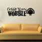 Vinyl wall decal with bold black 'Gobble Til you Wobble' text and turkey feather icon
