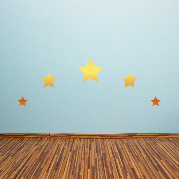 Gold and orange star stickers on a surface