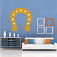Golden horseshoe sticker with white dot accents around the arch