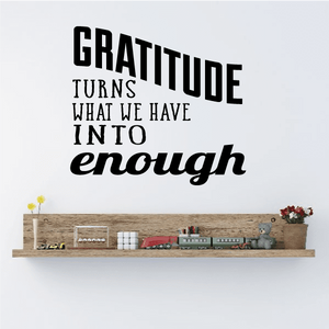 Wall decal quote "Gratitude turns what we have into enough" with small shelf scene