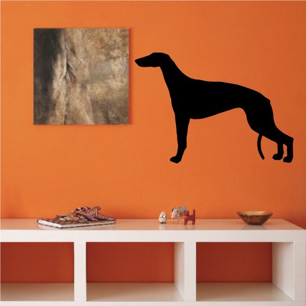 Black greyhound silhouette decal on orange wall