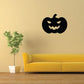 Black jack-o-lantern face wall decal with carved eyes and grin.