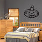 Black jack-o'-lantern wall decal with candle flame top