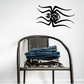 Black cartoon spider Halloween decal with wide eyes and web-like lines