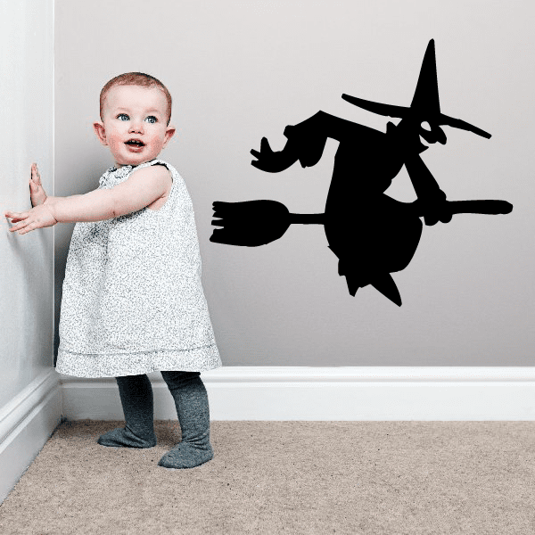 Image of Hand Reaching Back Riding a Broom Witch Decal