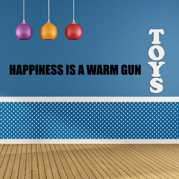 Wall decal with bold text: “HAPPINESS IS A WARM GUN” and vertical “TOYS”