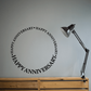 Happy Anniversary wall quote decal with circular black “Happy Anniversary” lettering