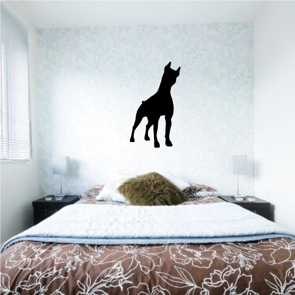Black head-tilt dog silhouette decal on a wall
