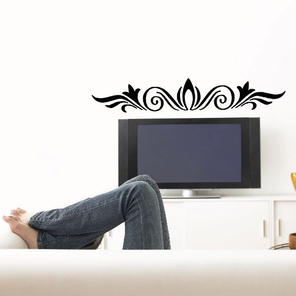Black vinyl decal sticker with ornate floral scroll design above headboard