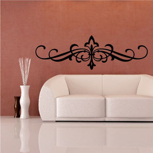 Ornate black vinyl wall decal with symmetrical scrolling design and center fleur
