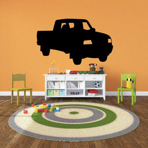 Vinyl wall decal of a dark pickup truck with illuminated headlights and grille.