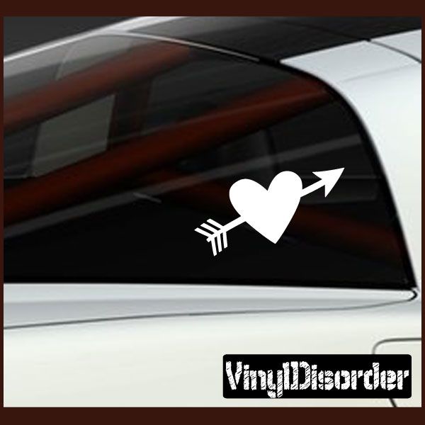 White heart decal pierced by arrow on car window, with small arrow detail.