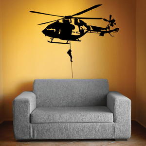 Helicopter dropline wall decal, black helicopter with hanging cord, over a gray sofa