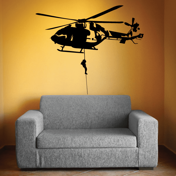Helicopter dropline wall decal, black helicopter with hanging cord, over a gray sofa