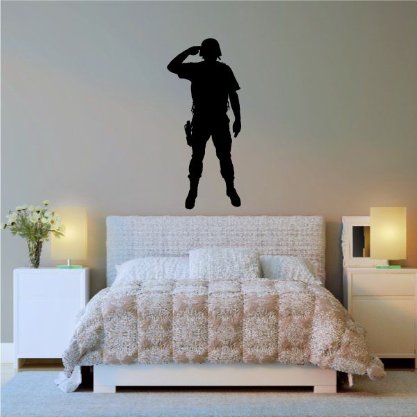 Helmeted soldier saluting decal, dark silhouette standing on wall above bed