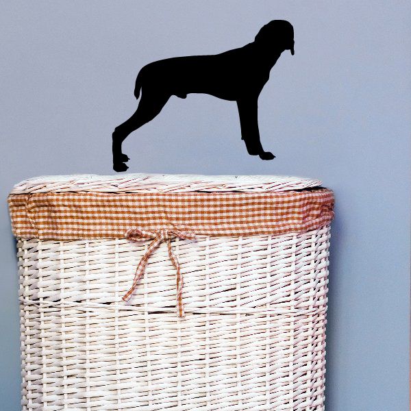 Black dog silhouette decal on top of a woven wicker basket