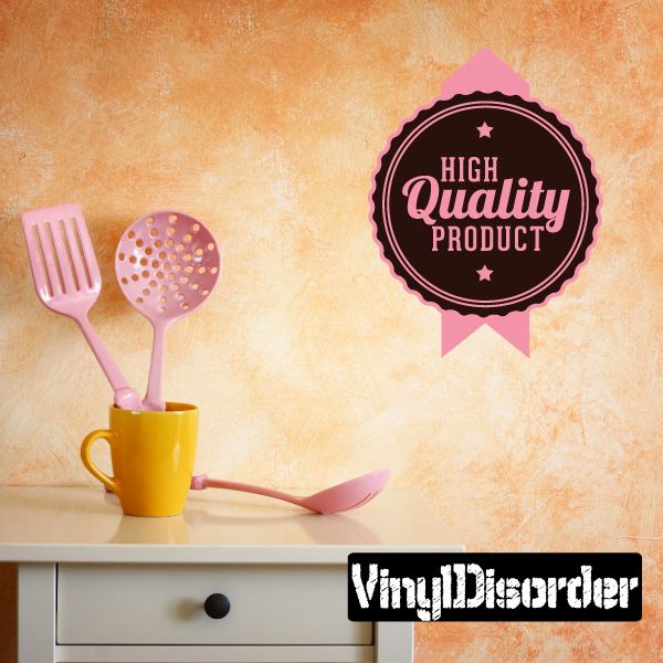 Vinyl badge wall decal: black circle with pink ribbon, text "High Quality Product"