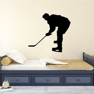 Hockey player vinyl decal with black silhouette holding a hockey stick