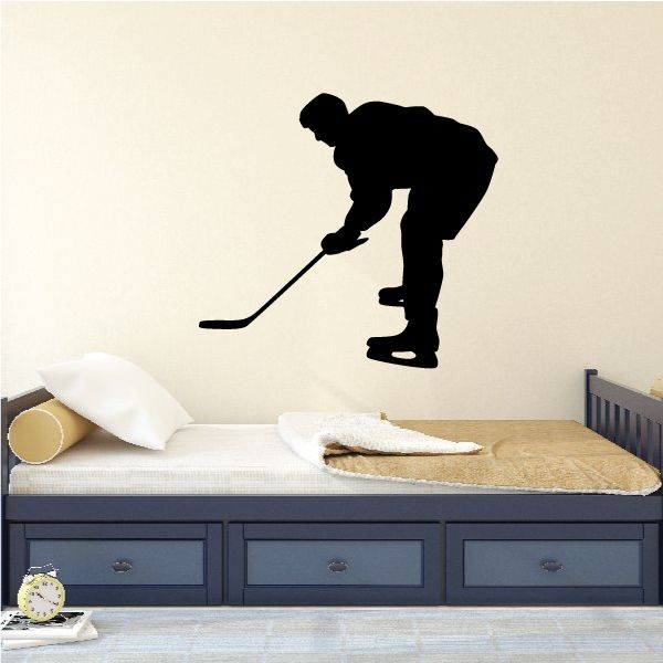 Hockey player vinyl decal with black silhouette holding a hockey stick