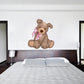 Plush dog sticker of a brown puppy holding a pink heart-pattern bandana