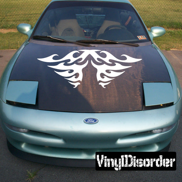 Car hood with white tribal flame decal design centered under windshield.