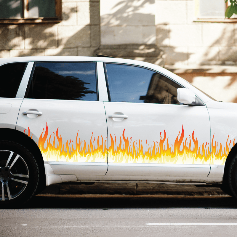 Flame graphic vinyl decal strip on white car door, orange and yellow fire pattern