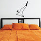 Seagull wall decal, black line-art bird with wings flapping above bed