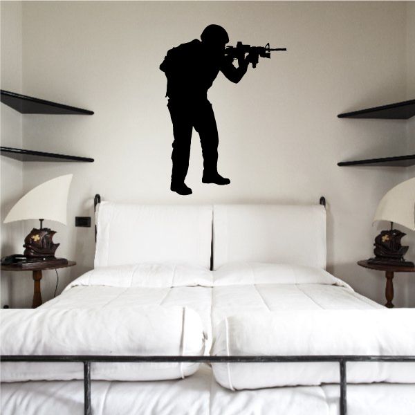 Hunched soldier aiming wall decal silhouette in dark black