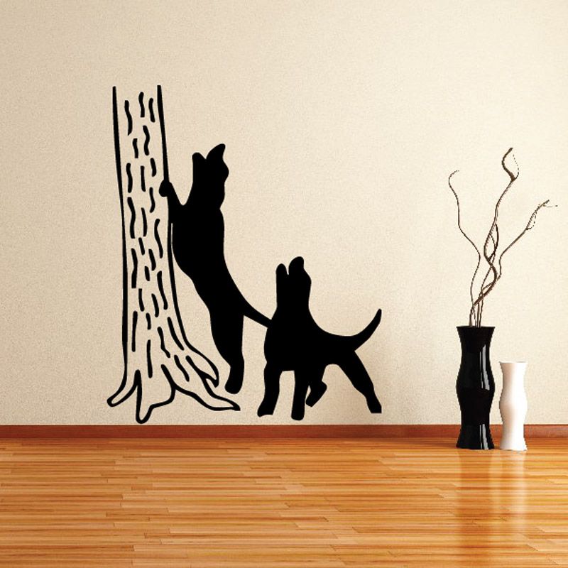 Two black dog silhouettes by tree trunk wall decal