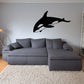 Orca whale decal sticker with black silhouette, side-view tail up on wall