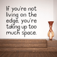 Wall quote decal with 'living on the edge' message and hourglass graphic