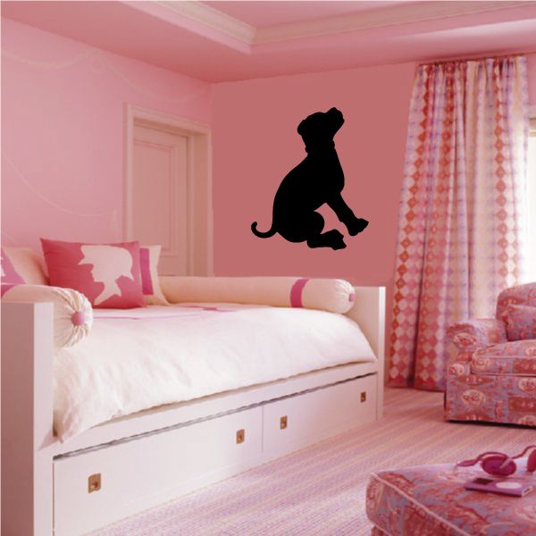 Black puppy silhouette wall decal, seated with paw raised