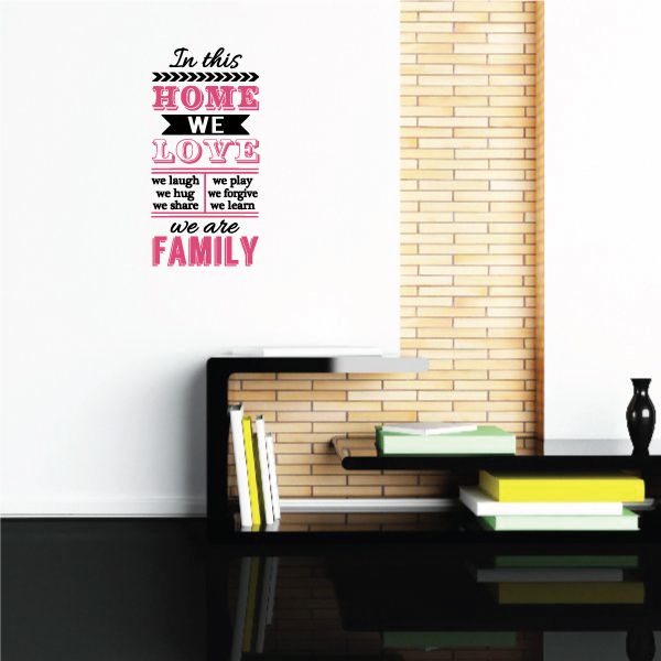 Printed wall decal text: In this home we love we are a family, colorful lettering