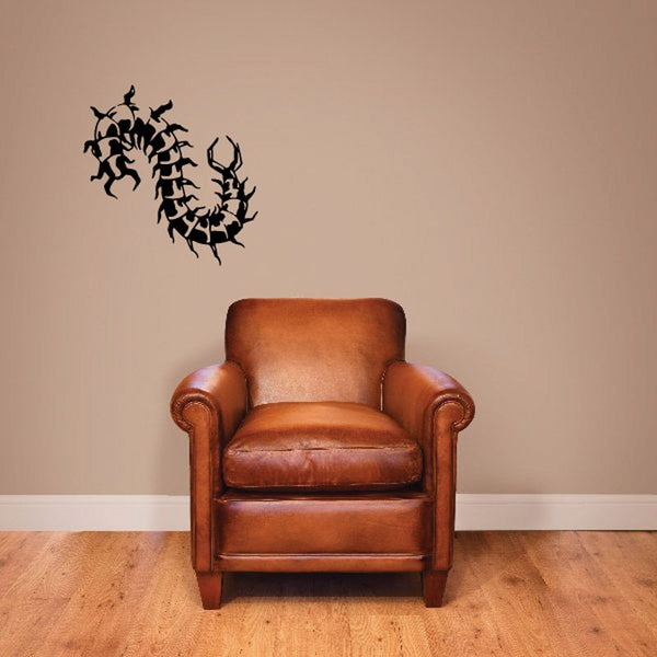 Black centipede jaw decal with stylized creature silhouette on a light wall